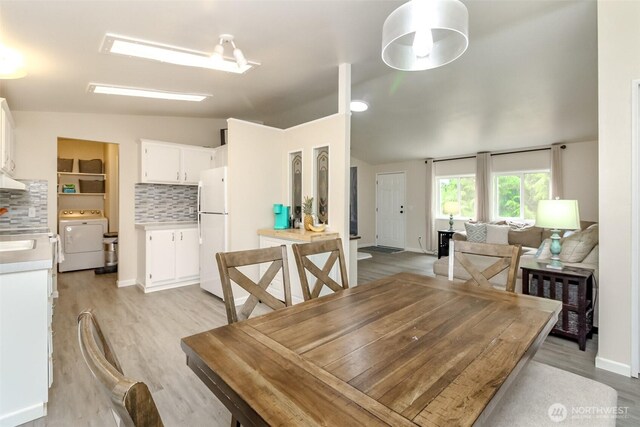 15816 251st St E, Graham, WA 98338 - dining area with washer / clothes dryer and light wood-style flooring