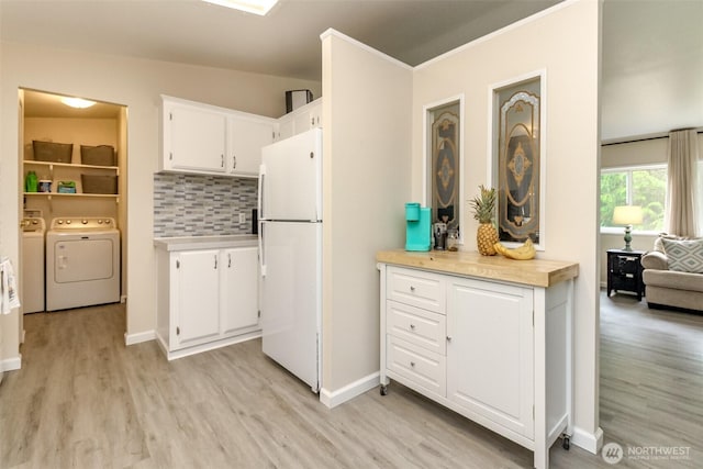 15816 251st St E, Graham, WA 98338 - kitchen featuring freestanding refrigerator, light countertops, light wood-type flooring, white cabinets, and tasteful backsplash