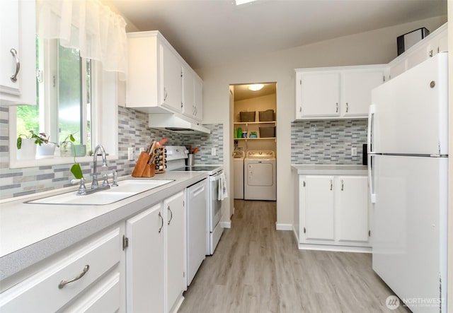 15816 251st St E, Graham, WA 98338 - kitchen with white appliances, washing machine and dryer, under cabinet range hood, light wood-type flooring, and light countertops