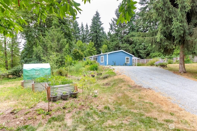 15816 251st St E, Graham, WA 98338 - view of yard featuring driveway and a garden