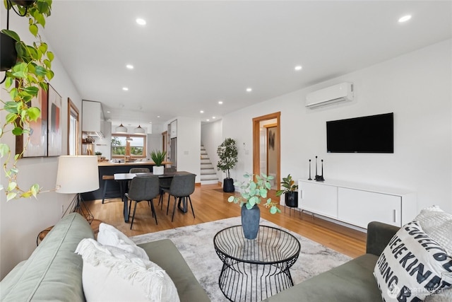 3211 16th Ave S, Seattle, WA 98144 - living area featuring a wall mounted air conditioner, stairs, recessed lighting, and light wood-type flooring