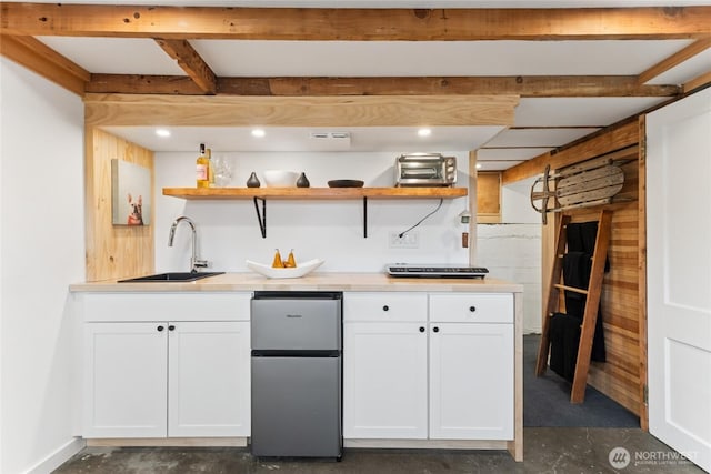 3211 16th Ave S, Seattle, WA 98144 - kitchen featuring freestanding refrigerator, concrete floors, white cabinets, open shelves, and light countertops