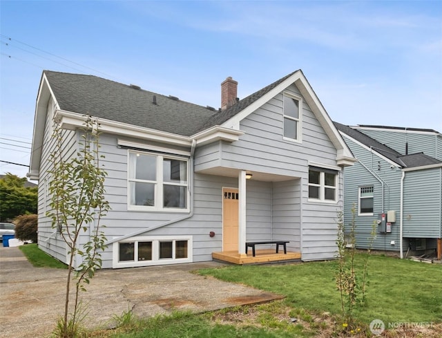 3211 16th Ave S, Seattle, WA 98144 - rear view of house featuring a chimney, a yard, a patio, and a shingled roof