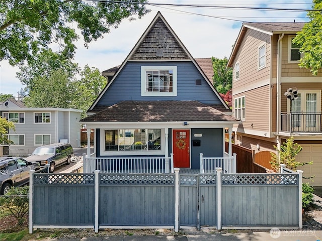 111 27th Ave S, Seattle, WA 98144 - view of front facade featuring a porch, a shingled roof, and a fenced front yard