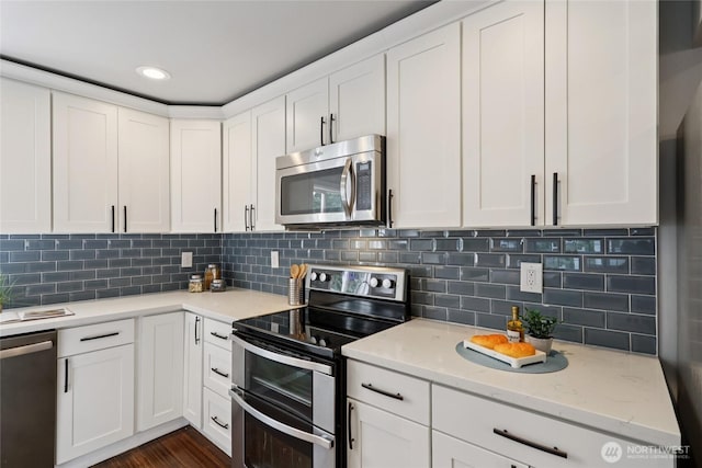 111 27th Ave S, Seattle, WA 98144 - kitchen featuring stainless steel appliances, white cabinets, light stone countertops, and tasteful backsplash