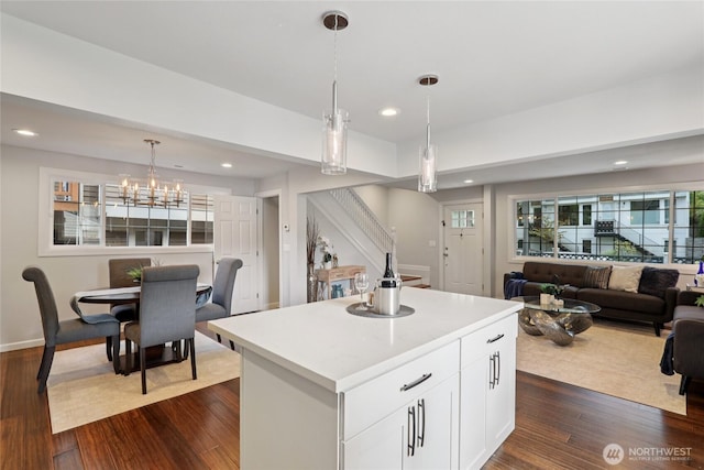 111 27th Ave S, Seattle, WA 98144 - kitchen with light countertops, white cabinetry, a kitchen island, dark wood finished floors, and open floor plan
