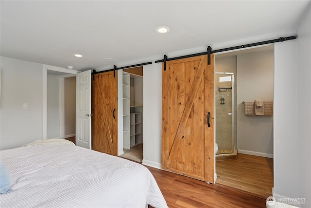 111 27th Ave S, Seattle, WA 98144 - bedroom with a barn door, recessed lighting, wood finished floors, a walk in closet, and connected bathroom