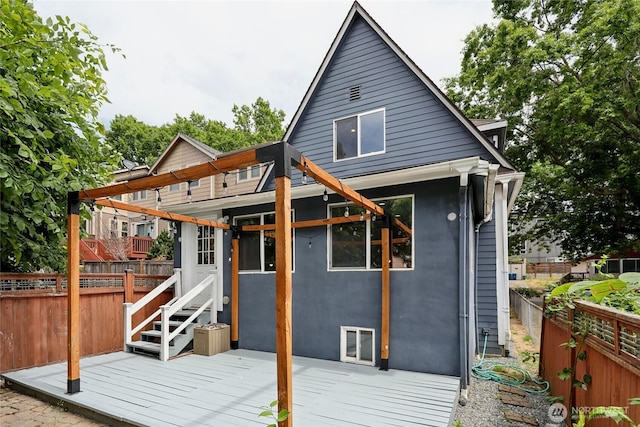 111 27th Ave S, Seattle, WA 98144 - back of property featuring a wooden deck, a fenced backyard, and stucco siding