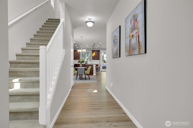 11103 5th Ave SW, Seattle, WA 98146 - hallway featuring stairs, light wood-type flooring, a chandelier, and recessed lighting