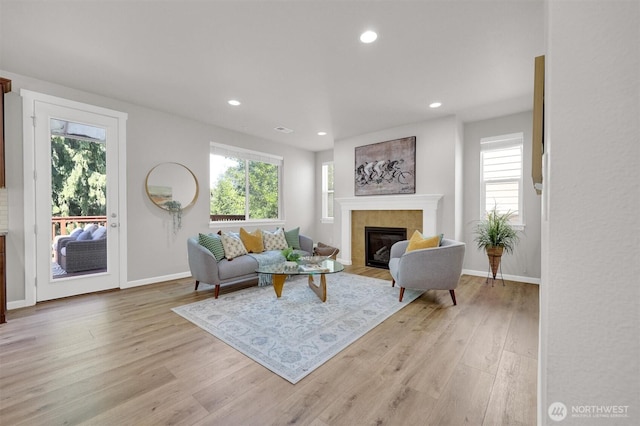 11103 5th Ave SW, Seattle, WA 98146 - living room with plenty of natural light, light wood-style floors, recessed lighting, and a tiled fireplace