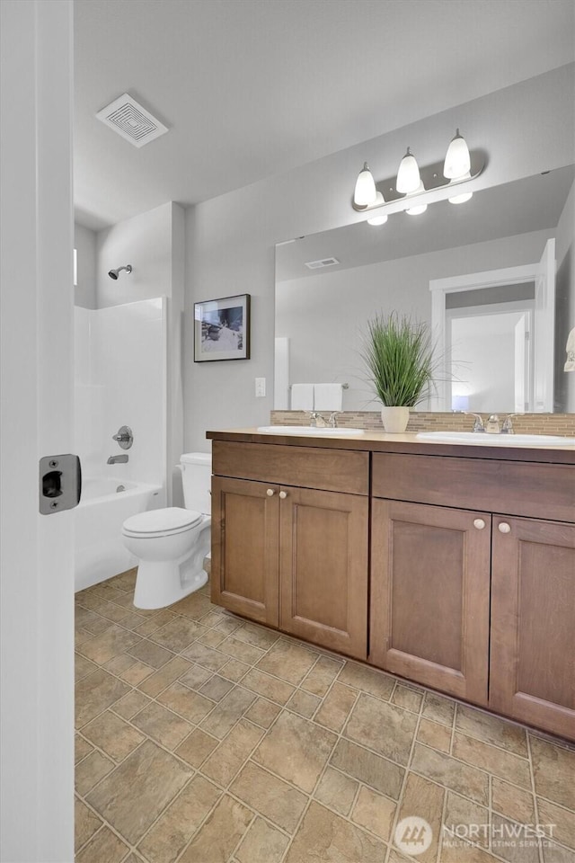 11103 5th Ave SW, Seattle, WA 98146 - bathroom with double vanity, stone finish floors, and shower / bathtub combination