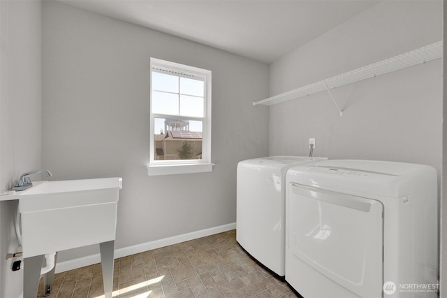 11103 5th Ave SW, Seattle, WA 98146 - laundry room featuring washer and clothes dryer and baseboards