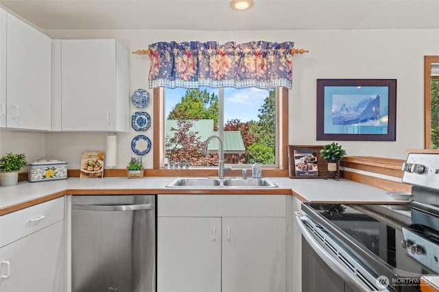 106 River St, Leavenworth, WA 98826 - kitchen with appliances with stainless steel finishes, light countertops, and white cabinetry