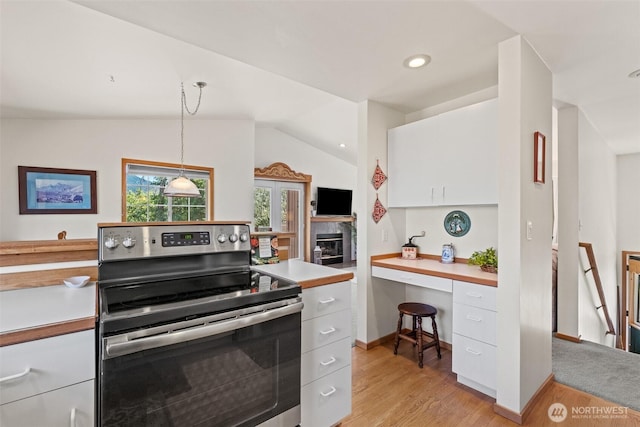 106 River St, Leavenworth, WA 98826 - kitchen featuring stainless steel electric range oven, light wood-type flooring, white cabinetry, light countertops, and vaulted ceiling