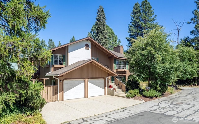 106 River St, Leavenworth, WA 98826 - view of front of property featuring concrete driveway and a chimney