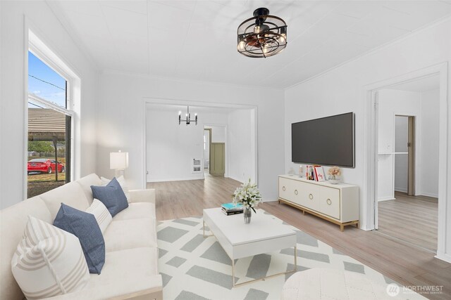 2104 Stuart St, Raymond, WA 98577 - living room featuring a chandelier, wood finished floors, and crown molding
