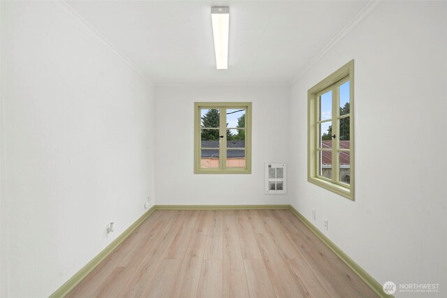 2104 Stuart St, Raymond, WA 98577 - spare room featuring light wood-style flooring, heating unit, and ornamental molding