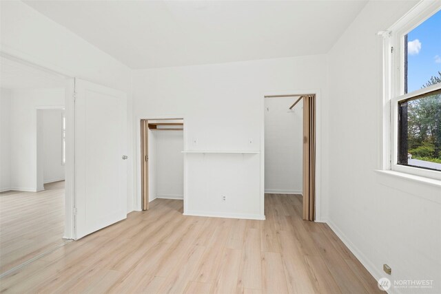 2104 Stuart St, Raymond, WA 98577 - unfurnished bedroom featuring a spacious closet and light wood-style floors