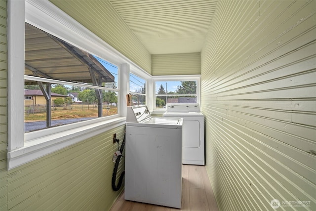 2104 Stuart St, Raymond, WA 98577 - laundry area featuring independent washer and dryer, wood finished floors, and wood walls