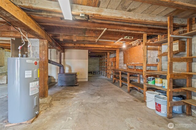 2104 Stuart St, Raymond, WA 98577 - unfinished basement with water heater and a wood stove