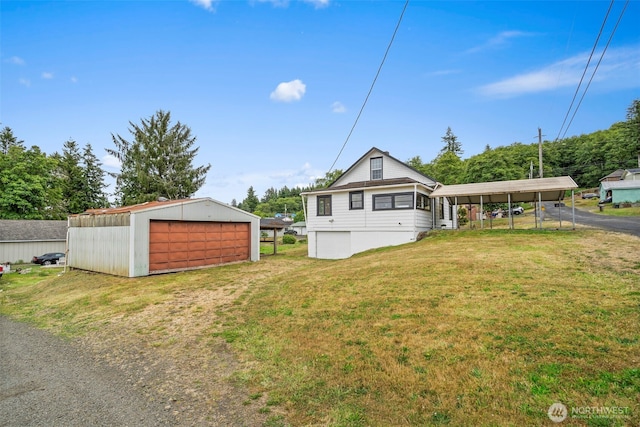 2104 Stuart St, Raymond, WA 98577 - view of front of home featuring an outbuilding, a front lawn, and a detached carport