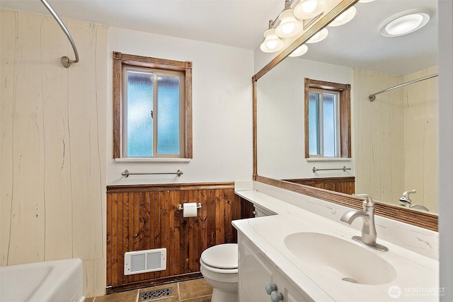 383 E Piper Way, Camano Island, WA 98282 - full bath with vanity, tile patterned flooring, heating unit,  shower combination, and wood walls