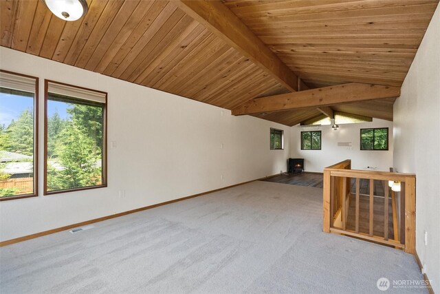 383 E Piper Way, Camano Island, WA 98282 - unfurnished living room featuring wooden ceiling, carpet flooring, and a wood stove