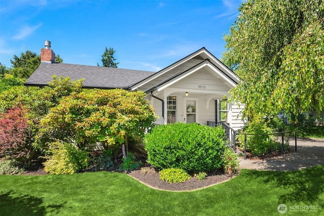 32112 E Bird St, Carnation, WA 98014 - view of front of home with a front lawn, a chimney, and roof with shingles