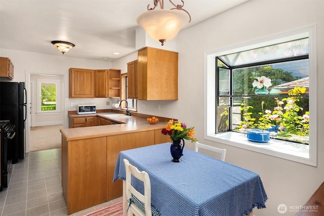 32112 E Bird St, Carnation, WA 98014 - kitchen with black appliances, open shelves, a peninsula, light countertops, and brown cabinetry