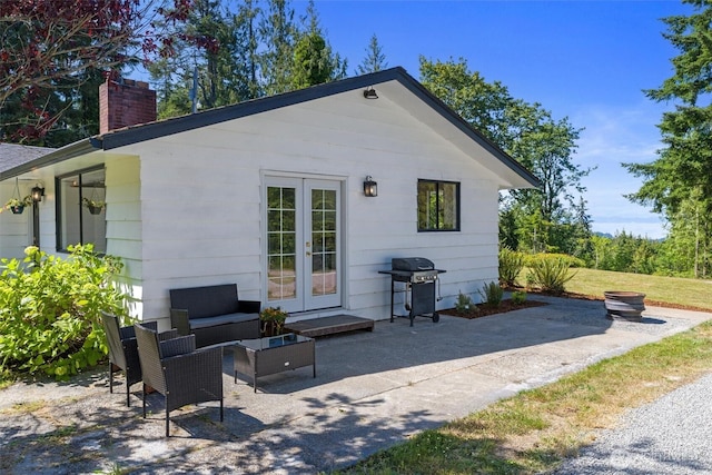 1173 Grauel Ramapo Rd, Port Angeles, WA 98363 - rear view of property with a patio area, french doors, a chimney, and an outdoor hangout area