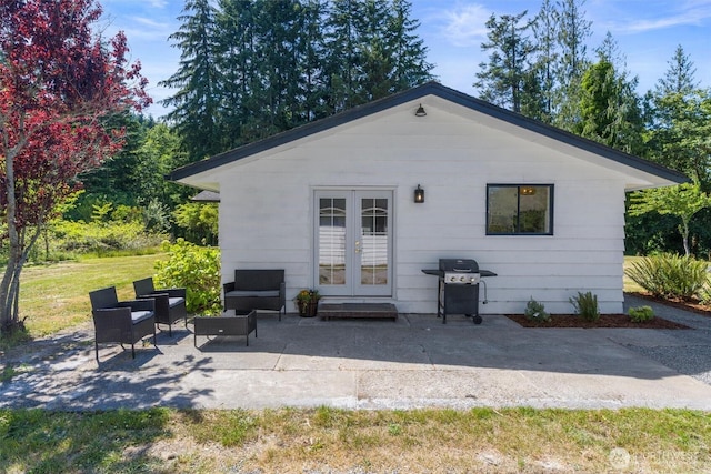 1173 Grauel Ramapo Rd, Port Angeles, WA 98363 - rear view of house featuring french doors, a patio area, an outdoor hangout area, and a lawn