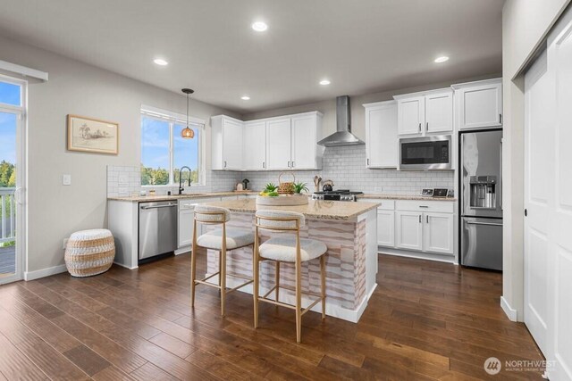 19042 123rd Ave SE, Renton, WA 98058 - kitchen with appliances with stainless steel finishes, wall chimney range hood, decorative backsplash, white cabinets, and recessed lighting