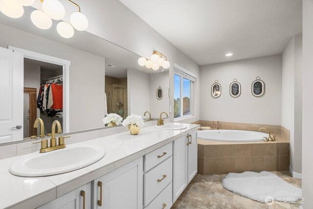 19042 123rd Ave SE, Renton, WA 98058 - full bathroom with double vanity, a garden tub, a spacious closet, an enclosed shower, and stone finish floors
