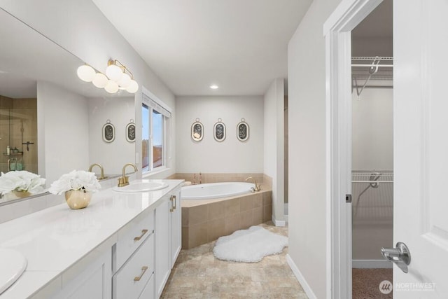 19042 123rd Ave SE, Renton, WA 98058 - full bath featuring a garden tub, double vanity, a walk in closet, and a stall shower