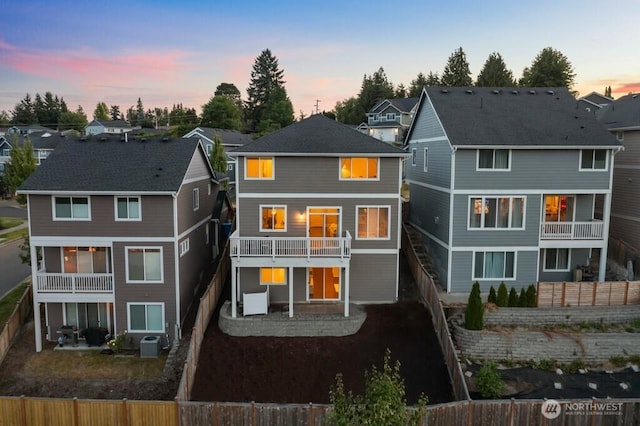 19042 123rd Ave SE, Renton, WA 98058 - back of property at dusk with a patio, a fenced backyard, and a residential view