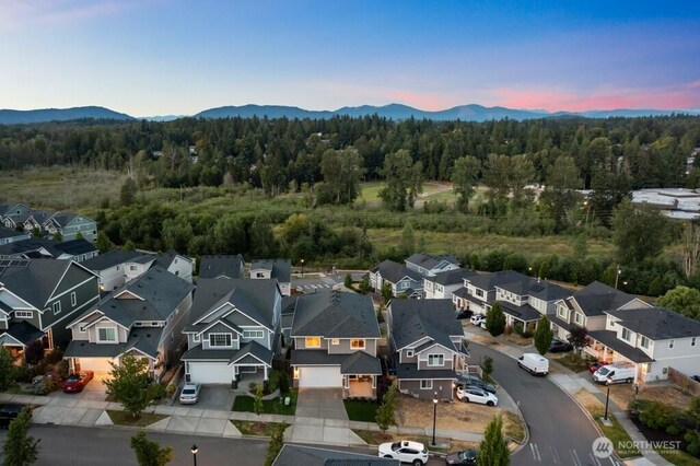19042 123rd Ave SE, Renton, WA 98058 - aerial view at dusk of a mountain view, a wooded view, and a residential view