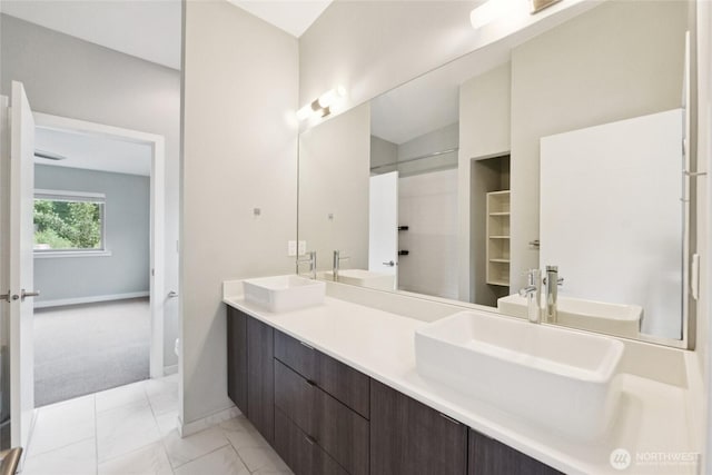 4214 S Trenton St, Seattle, WA 98118 - full bathroom with double vanity, marble finish flooring, and a shower