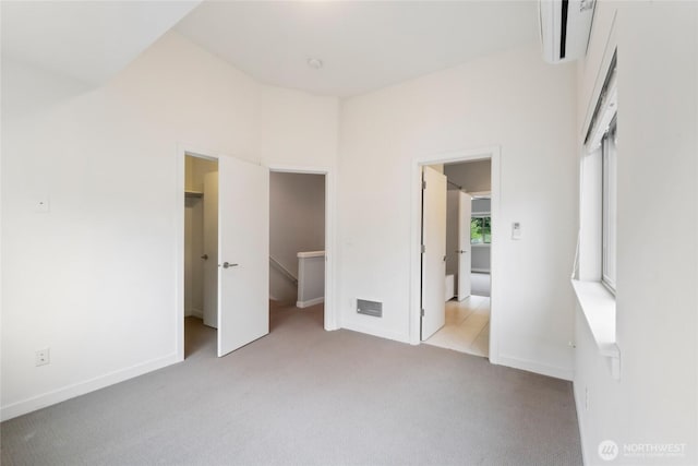 4214 S Trenton St, Seattle, WA 98118 - unfurnished bedroom featuring a wall unit AC, a spacious closet, and carpet