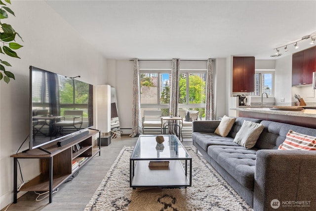 1400 Hubbell Pl Unit 909, Seattle, WA 98101 - living room with light wood-type flooring and rail lighting