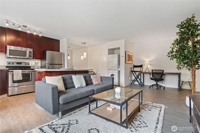 1400 Hubbell Pl Unit 909, Seattle, WA 98101 - living area with stacked washer / drying machine and light wood-style flooring