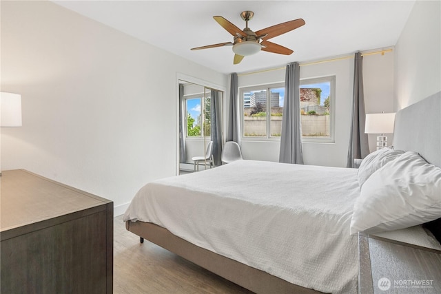 1400 Hubbell Pl Unit 909, Seattle, WA 98101 - bedroom with wood finished floors and ceiling fan