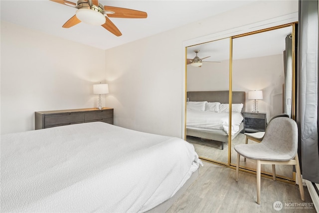 1400 Hubbell Pl Unit 909, Seattle, WA 98101 - bedroom with wood finished floors, a closet, and ceiling fan