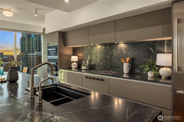 1920 4th Ave Unit 1105, Seattle, WA 98101 - kitchen with stainless steel double oven, gray cabinetry, gas cooktop, backsplash, and modern cabinets