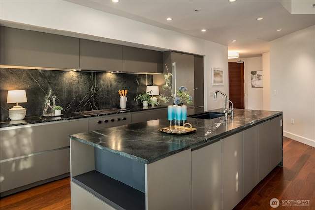 1920 4th Ave Unit 1105, Seattle, WA 98101 - kitchen with modern cabinets, decorative backsplash, dark wood-type flooring, recessed lighting, and an island with sink