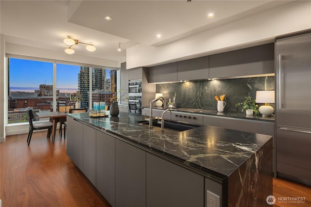 1920 4th Ave Unit 1105, Seattle, WA 98101 - kitchen featuring modern cabinets, gray cabinetry, appliances with stainless steel finishes, a spacious island, and recessed lighting