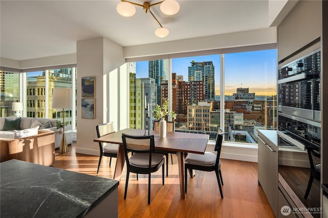 1920 4th Ave Unit 1105, Seattle, WA 98101 - dining space with wood finished floors and a city view