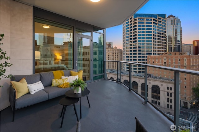 1920 4th Ave Unit 1105, Seattle, WA 98101 - balcony at dusk with a view of city and an outdoor hangout area
