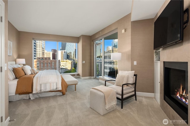 1920 4th Ave Unit 1105, Seattle, WA 98101 - bedroom with a warm lit fireplace, access to exterior, and light carpet