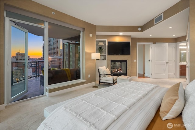 1920 4th Ave Unit 1105, Seattle, WA 98101 - carpeted bedroom featuring a multi sided fireplace, access to exterior, and multiple windows