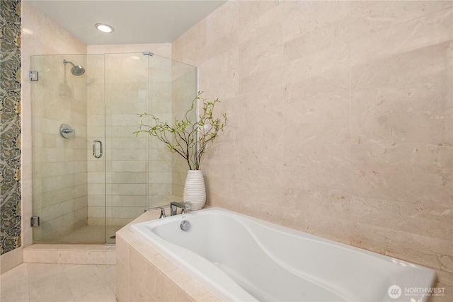 1920 4th Ave Unit 1105, Seattle, WA 98101 - full bathroom with a garden tub, a shower stall, tile walls, and recessed lighting